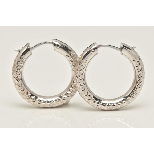 22 - A PAIR OF WHITE METAL HOOP EARRINGS, hollow hoops with diamond cut pattern detail, fitted with hinge... 