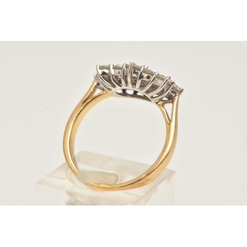 26 - AN 18CT GOLD DIAMOND CLUSTER RING, three baguette cut diamonds, prong set with a surround of twelve ... 