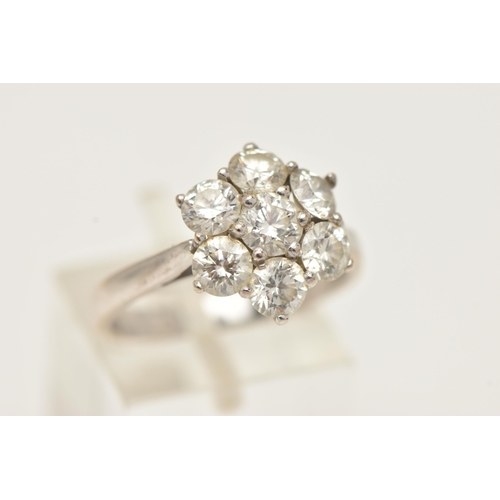 27 - AN 18CT GOLD DIAMOND CLUSTER RING, seven round brilliant cut diamonds, prong set in white gold, appr... 