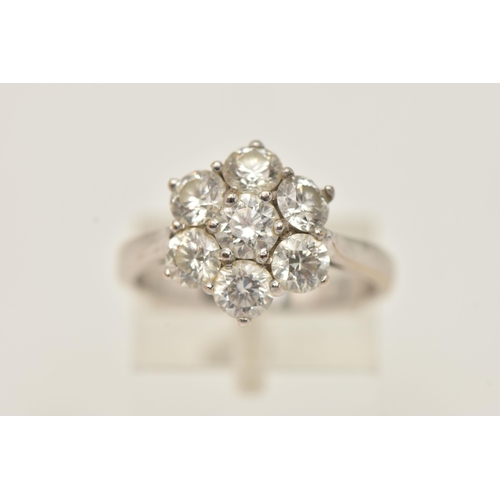 27 - AN 18CT GOLD DIAMOND CLUSTER RING, seven round brilliant cut diamonds, prong set in white gold, appr... 