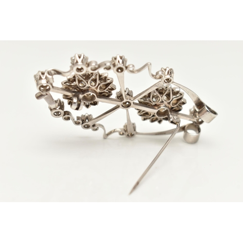 44 - AN 18CT WHITE GOLD AND DIAMOND PENDANT BROOCH, designed as an open work navette form brooch, central... 