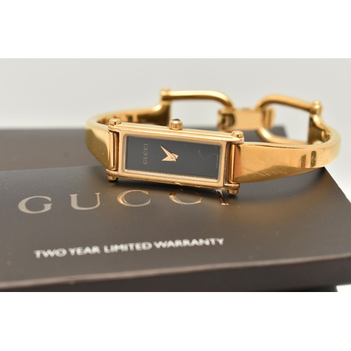 52 - A LADIES 'GUCCI' WRISTWATCH, quartz movement, rectangular black dial, signed 'Gucci', gold plated ca... 