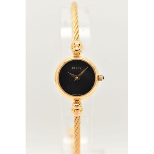 53 - A LADIES 'GUCCI' WRISTWATCH, quartz movement, round black dial, signed 'Gucci', gold plated case, ap... 