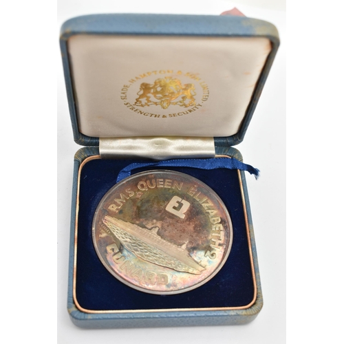 58 - A CASED SILVER MEDALLION, 'RMS Queen Elizabeth 2 Cunard Maiden Voyage' medallion, hallmarked London ... 