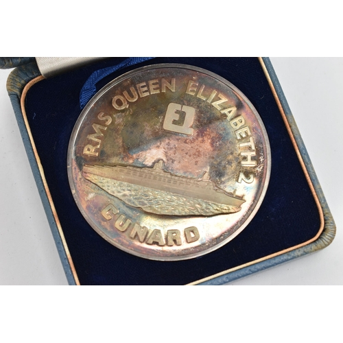 58 - A CASED SILVER MEDALLION, 'RMS Queen Elizabeth 2 Cunard Maiden Voyage' medallion, hallmarked London ... 