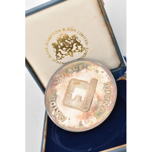 58 - A CASED SILVER MEDALLION, 'RMS Queen Elizabeth 2 Cunard Maiden Voyage' medallion, hallmarked London ... 