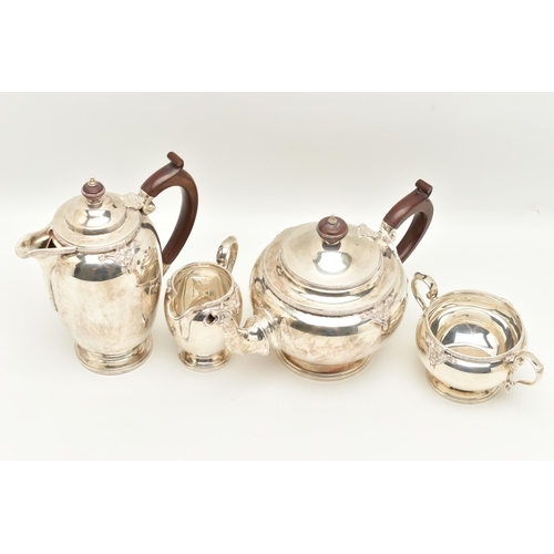 67 - A GEORGE V SILVER FOUR PIECE TEA SERVICE, cast with a band of quatrefoil decoration and foliate scro... 