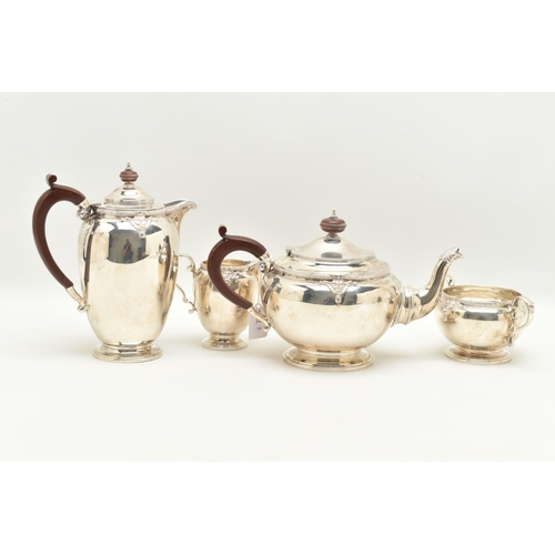 67 - A GEORGE V SILVER FOUR PIECE TEA SERVICE, cast with a band of quatrefoil decoration and foliate scro... 