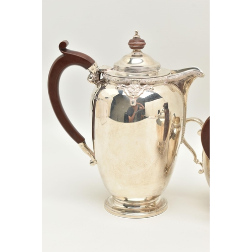 67 - A GEORGE V SILVER FOUR PIECE TEA SERVICE, cast with a band of quatrefoil decoration and foliate scro... 