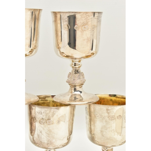 70 - A SET OF SIX ELIZABETH II SILVER GOBLETS, the bucket shaped bowl with gilt interior, on stem cast wi... 