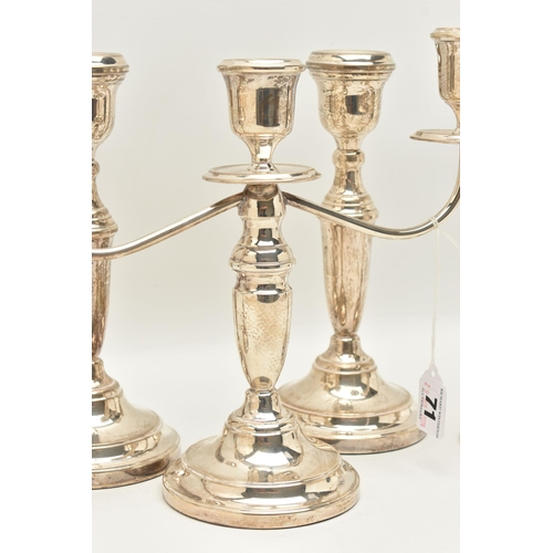 71 - TWO PAIRS OF ELIZABETH II SILVER CANDLESTICKS AND AN ELIZABETH II THREE LIGHT CANDELABRUM, all of a ... 