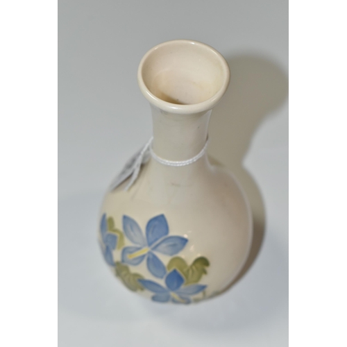 361 - A MOORCROFT POTTERY 'BLUE CAMPANULA' BUD VASE, tube lined with pale blue campanula flowers on a crea... 