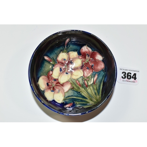 364 - A MOORCROFT POTTERY 'FREESIA' FOOTED BOWL, tube lined with pink and pale yellow Freesia on a dark bl... 