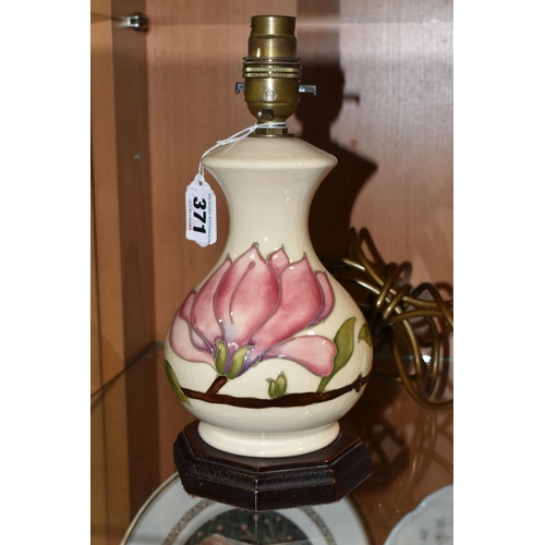 371 - A MOORCROFT POTTERY 'MAGNOLIA' PATTERN TABLE LAMP BASE, tube lined with pink magnolia flowers on a c... 