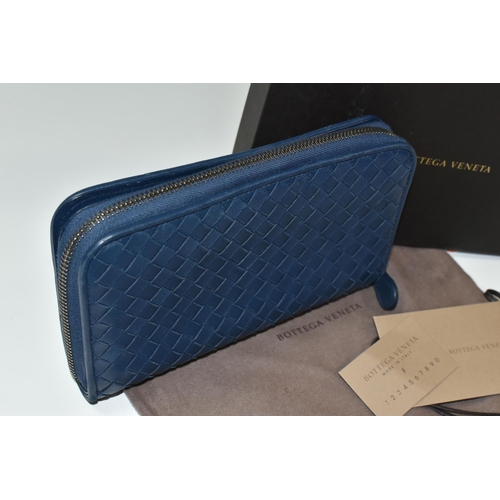 406 - A BOXED BOTTEGA VENETA BLUE LEATHER PURSE, with a woven leather design, original shop tags, dust bag... 