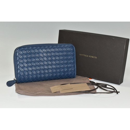 406 - A BOXED BOTTEGA VENETA BLUE LEATHER PURSE, with a woven leather design, original shop tags, dust bag... 