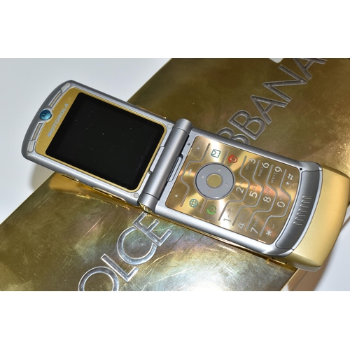 408 - A DOLCE & GABBANA BOXED MOTOROLLA RAZR V3i MOBILE PHONE, in original gold and silver packaging, with... 