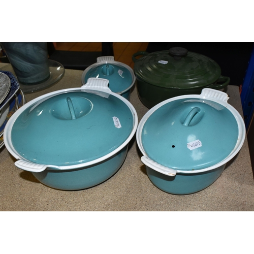 426 - FOUR LE CREUSET CASSEROLE DISHES to include a lidded 18cm turquoise dish, a circular 24cm ovoid turq... 