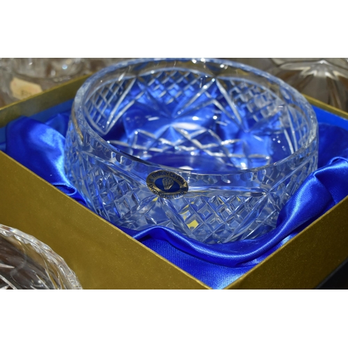 438 - A LARGE GROUP OF CRYSTAL CUT GLASSES to include a boxed Tutbury Crystal fruit bowl, a pair of etched... 