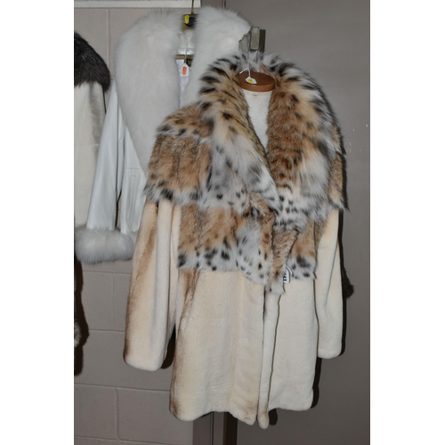 443 - THREE LADIES' LEATHER AND FUR JACKETS, comprising a pale cream fur jacket with  lynx fur collar and ... 