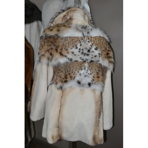 443 - THREE LADIES' LEATHER AND FUR JACKETS, comprising a pale cream fur jacket with  lynx fur collar and ... 