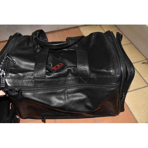 492 - TWO BLACK LEATHER TUMI HOLDALLS with leather name tags, height 28cm x length 40cm x width 20cm (2) (... 