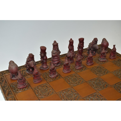 515 - AN ALICE IN WONDERLAND CHESS BOARD AND SET OF THIRTY TWO CHESS PIECES IN RED AND WHITE, comprising  ... 