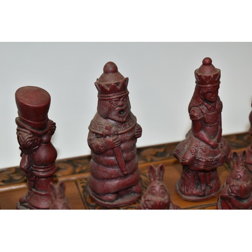 515 - AN ALICE IN WONDERLAND CHESS BOARD AND SET OF THIRTY TWO CHESS PIECES IN RED AND WHITE, comprising  ... 