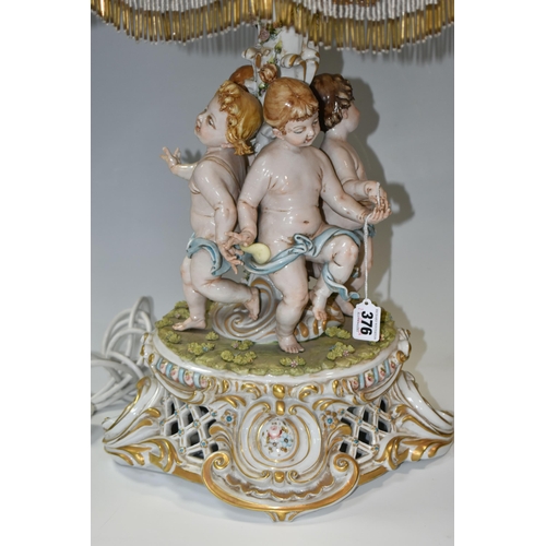 376 - A CAPODIMONTE PORCELAIN FIGURAL TABLE LAMP, signature 'Galletto', depicting four Putti dancing aroun... 