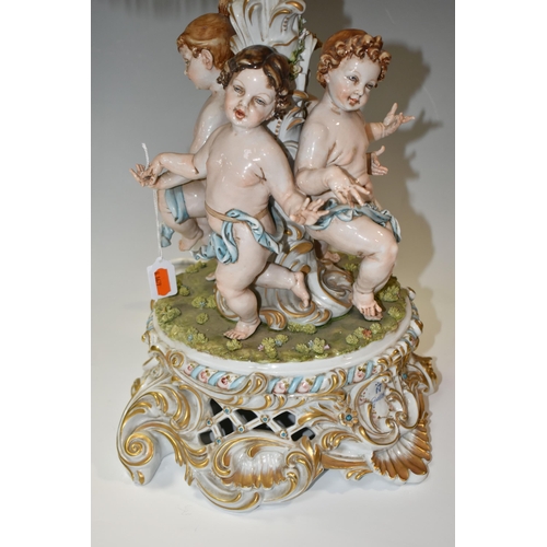 376 - A CAPODIMONTE PORCELAIN FIGURAL TABLE LAMP, signature 'Galletto', depicting four Putti dancing aroun... 