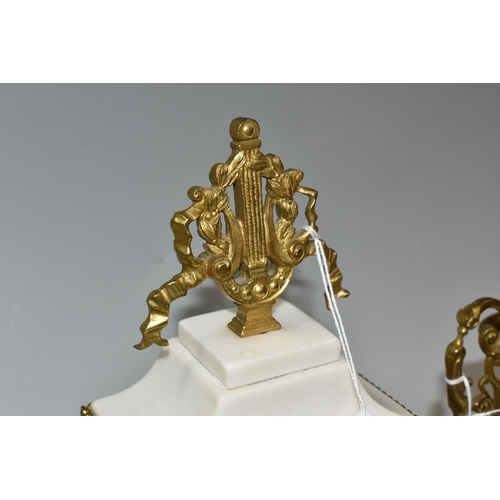 316 - AN ALABASTER AND GILT METAL CLOCK GARNITURE, the central clock flanked by two urns, case surmounted ... 