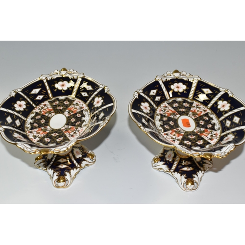 320 - TWO ROYAL CROWN DERBY IMARI 2451 COMPORTS, with twin handles in the forms of acorns, red printed bac... 