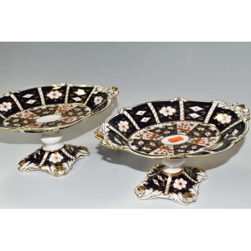 320 - TWO ROYAL CROWN DERBY IMARI 2451 COMPORTS, with twin handles in the forms of acorns, red printed bac... 