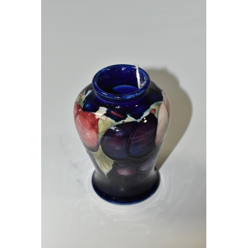 324 - A MOORCROFT POTTERY SMALL 'WISTERIA' PATTERN VASE, of baluster form, tube lined with red, purple and... 