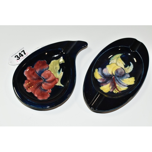 347 - TWO MOORCROFT POTTERY 'HIBISCUS' PATTERN ASHTRAYS, one of teardrop shape, tube lined with a pink/pur... 