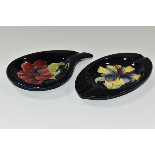 347 - TWO MOORCROFT POTTERY 'HIBISCUS' PATTERN ASHTRAYS, one of teardrop shape, tube lined with a pink/pur... 