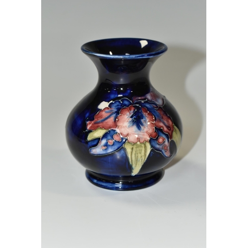 349 - A MOORCROFT POTTERY SMALL 'ORCHID' PATTERN VASE, of baluster form, tube lined with red, purple, blue... 