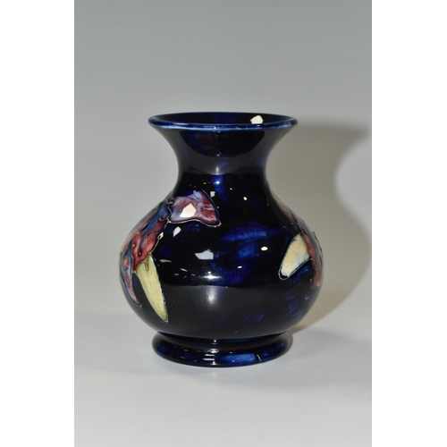 349 - A MOORCROFT POTTERY SMALL 'ORCHID' PATTERN VASE, of baluster form, tube lined with red, purple, blue... 