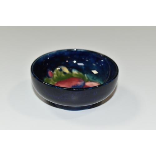 351 - A MOORCROFT POTTERY 'PANSY' SMALL FOOTED BOWL, tube lined with a pink and purple Pansy on a dark blu... 