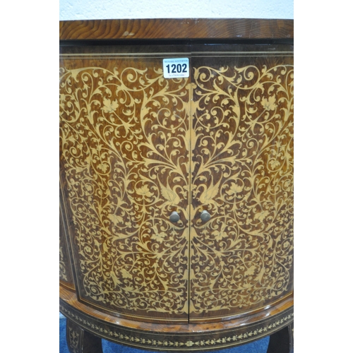 1202 - A REPRODUCTION ITALIAN BURR WOOD AND MARQUETRY INLAID DRINKS CABINET, the double doors enclosing var... 