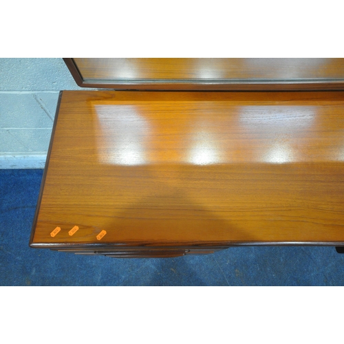 1209 - A MID CENTURY TEAK G PLAN DRESSING TABLE, with a rectangular mirror, fitted with four drawers, a cen... 