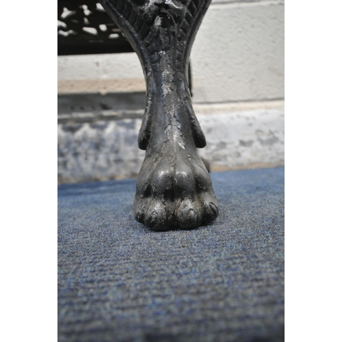 1216 - A VICTORIAN CAST IRON FOOTMAN, with brass insert, raised on four legs, the two front legs with paw f... 