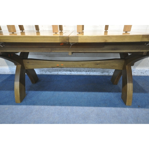 1218 - JB GLOBAL, A MODERN SOLID OAK EXTENDING TABLE, with two additional fold out leaves, raised on cross ... 