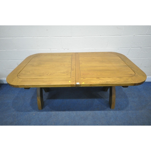 1218 - JB GLOBAL, A MODERN SOLID OAK EXTENDING TABLE, with two additional fold out leaves, raised on cross ... 