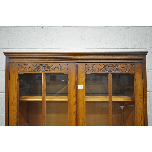 1232 - A 20TH CENTURY OAK BOOKCASE, with double glazed doors, above smaller double doors, width 93cm x dept... 