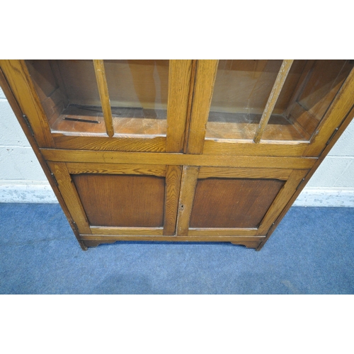 1232 - A 20TH CENTURY OAK BOOKCASE, with double glazed doors, above smaller double doors, width 93cm x dept... 