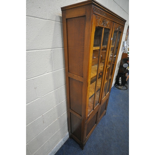 1232 - A 20TH CENTURY OAK BOOKCASE, with double glazed doors, above smaller double doors, width 93cm x dept... 