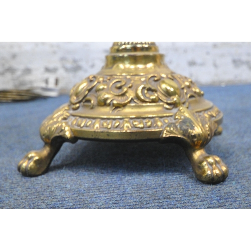 1235 - A PAIR OF BULBOUS BRASS TABLE LAMPS, with intricate details, raised on four paw feet, height to fitt... 