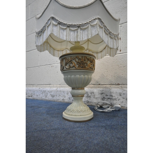 1235 - A PAIR OF BULBOUS BRASS TABLE LAMPS, with intricate details, raised on four paw feet, height to fitt... 