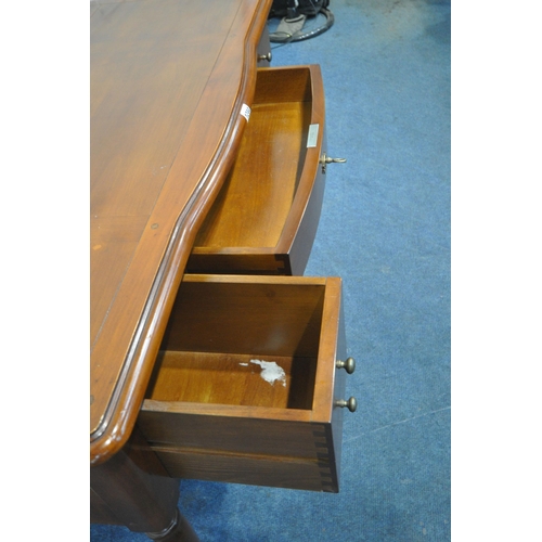 1244 - A CHERRYWOOD SIDE TABLE, fitted with an arrangement of four drawers, raised on cylindrical tapered l... 